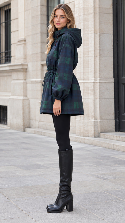 Side angle view of navy green plaid hooded jacket showing cinched waist and knee-high boots
