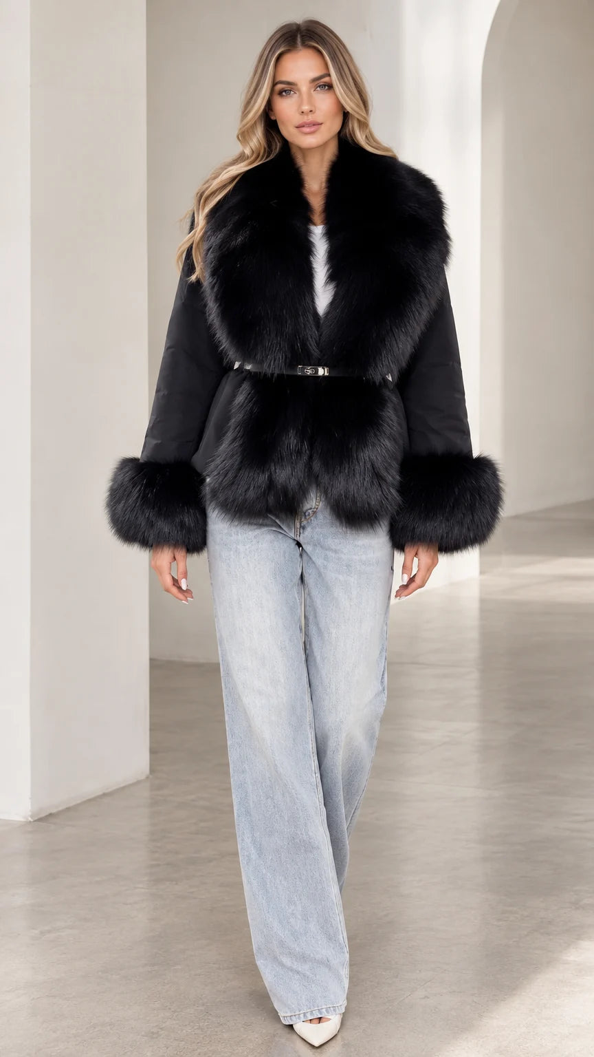 Front view of model wearing black belted jacket with plush faux fur collar and cuffs